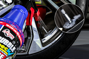 Bubble Check spraying a tire valve stem, bubbles revealing a slow valve leak